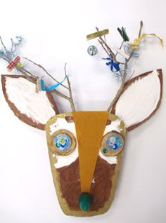 a paper mache deer head with blue eyes