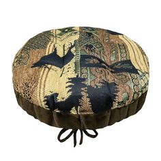 a round cushion with an animal pattern on it's side and ties around the edge