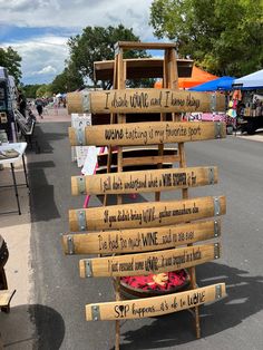 a sign made out of wooden planks with writing on it that says i drink wine and i know things