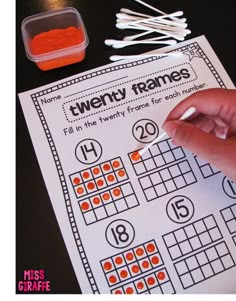 a hand is pointing at the numbers on a piece of paper that says twenty frames