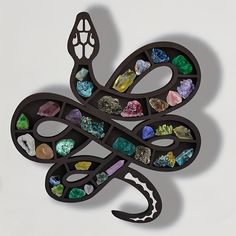 a snake shaped object with many different colored stones