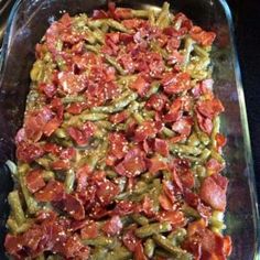 a casserole dish with green beans, tomatoes and other toppings on it