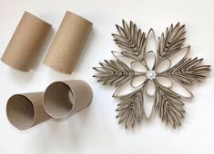 two toilet paper rolls, one with a snowflake design and the other with an ornament