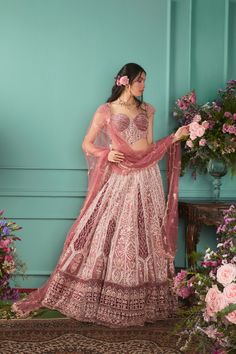 Featuring a rust rose lehenga set in velvet base with zardosi hand embroidery paired up with a corset style blouse with pearl detailing. It includes a net dupatta with tassels around the edges. DELIVERY TIMEPlease allow 8-12 weeks for your outfit to arrive. FABRIC DETAILSLehenga- Velvet, Blouse- Net & Velvet, Dupatta- Net Professional cleaning only. Lehenga Velvet, Velvet Dupatta, Velvet Lehenga, Wedding Sari, Raw Silk Fabric, Indian Bridal Lehenga, Add Sleeves, Velvet Blouse, Padded Blouse