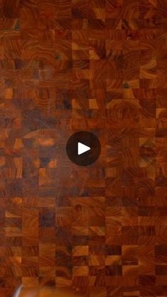 a close up of a wooden cutting board with a video playing on the top right corner