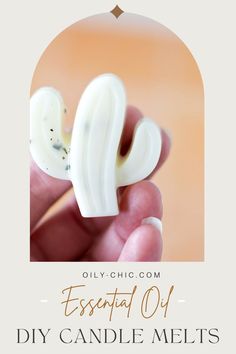 a hand holding a small white object with the words essential oil diy candle melts