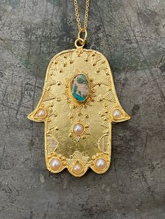 Hamsa Hand is very meaningful in many traditions. It's believed keep away from bad luck and negative things then turn them to Positive energy!! 21 ct gold plated brass. Turquoise and Pearl Length - Approx 83cm / top 6,5 x 5 cm Designed by our Turkish designer. Handcrafted with great care. Hamsa Hand Necklace, Fatima Hand, Hamsa Necklace, Hand Necklace, Gift For Woman, Hand Of Fatima, Bad Luck, Hamsa Hand, Jewelry Inspo