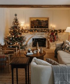 a living room filled with furniture and a fire place next to a christmas decorated tree