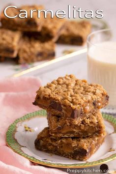 two pieces of granola bars on a plate with a glass of milk