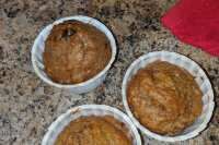 three small white bowls filled with food on top of a counter