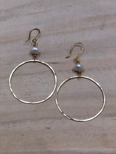 Hand Formed and hammer hoop earrings with wired Freshwater Pearl. These earrings are feather light and elegant and go with everything! Hoop measures approximately 1 1/2 inches. Hammered Metal Circle Hoop Earrings, Hammered Adjustable Small Hoop Earrings, Small Hammered Adjustable Hoop Earrings, Gold Hoop Pearl Earrings Nickel Free, Small Hammered Hoop Earrings, Small Hoop Metal Pearl Earrings For Pierced Ears, Adjustable Hoop Earrings With Ear Wire, Hammered Metal Hoop Jewelry, Adjustable Hammered Hoop Earrings