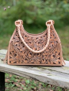 Hand-tooled leather Hobo "Luna" with beautiful embossed design in front and honeycomb on the back, elegant and chic! With enough space to carry all your basics plus more. Perfect as a gift for her.Size 15.5" W x 13 "H x 4 1/2" D (approximate)Interior features zip pocket and two side pocketExterior Leaf design on the front and honeycomb on the backTwo Magnetic closure of the nude color / Zip closure on tan italiano & Honey ColorTwo braided handles 10" dropTwo tassels on the sides Metal feet prote Mexican Western, Tooled Leather Handbags, Tooled Leather Bag, Tooled Leather Purse, Honey Color, Embossed Design, Luxury Bag, Black Leather Purse, Hand Tooled Leather