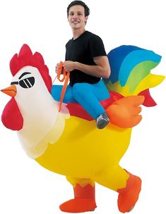 a man is riding on an inflatable chicken