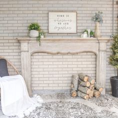 a fireplace in a living room with logs and potted plants on the mantel