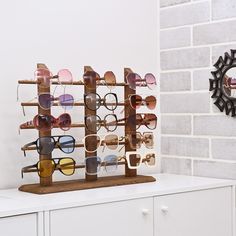 Product Details 15-Pair Sunglasses Display Stand Features SUNGLASS GLASSES DISPLAY RACK: This rustic wooden sunglasses display rack is ideal for storing and showcasing up to 15 eyewear items, such as glasses and jewelry. Wooden Glasses Holder, Eyeglass Display, Sunglasses Rack, Sunglass Organizer, Glasses Organizer, Glasses Display, Eyewear Display, Sunglasses Organizer, Wooden Glasses