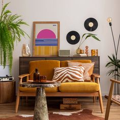 a living room filled with lots of furniture next to a potted plant on top of a table