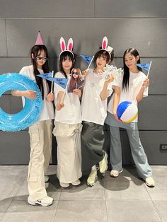 four girls in bunny ears holding up signs