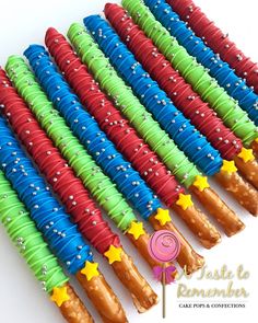 there are many different colored candy sticks with stars on them in the shape of wands