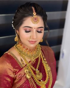 a woman in a red sari with gold jewelry