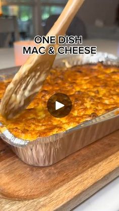 a person using a spatula to dip cheese into a casserole