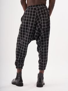 Checkered black Harem Pants style joggers for men. Baggy loose fit with drawstring. Drop-crotch style joggers with 2 side pockets. FEATURES Slim Fit Made up of 95% Cotton and 5% Elastane Jogger comfort Drawstring waist SIZE GUIDE Model's height and weight: 6"1 feet & 180 lbs. (185 cm & 82 kg ) Model wears size: L Black Harem Pants For Winter, Black Relaxed Fit Harem Pants For Winter, Winter Black Harem Pants With Elastic Waistband, Black Harem Pants With Elastic Waistband For Winter, Black Elastic Waistband Harem Pants For Winter, Baggy Black Joggers With Side Pockets, Winter Streetwear Harem Pants With Relaxed Fit, Streetwear Harem Pants With Side Pockets And Tapered Leg, Casual Baggy Drop Crotch Sweatpants