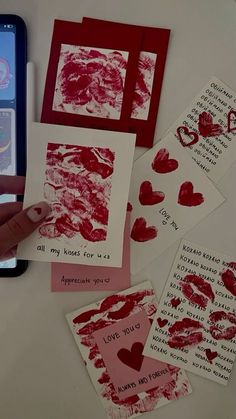 someone is making valentine cards with their cell phone