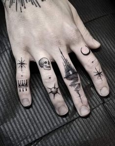 a person's hand with tattoos on it