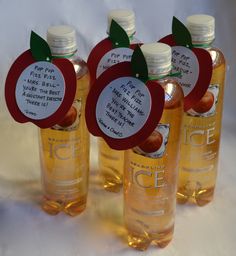 four bottles of apple cider vinegar with labels on them for the apples to be picked