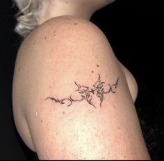 a woman's arm with a tattoo on it that has flowers growing out of it