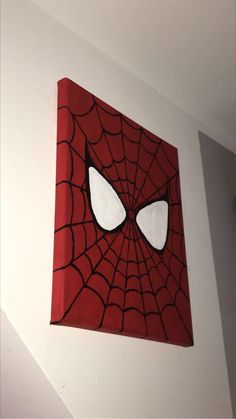 a spider - man painting on the wall in a room with white walls and ceiling