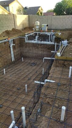 the foundation is being constructed for a house in the yard, with pipes running through it