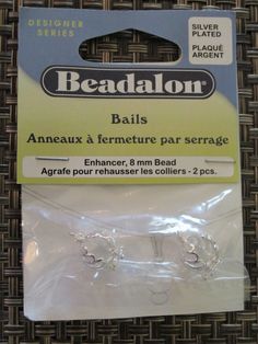 beadalon beads for making bracelets and necklaces in clear plastic packaging on a woven surface