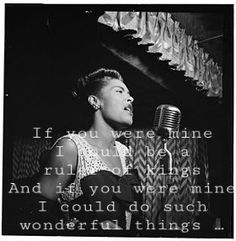 a black and white photo of a woman singing into a microphone