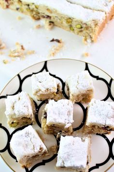 several pieces of cake sitting on a plate next to a slice of cake that has been cut in half