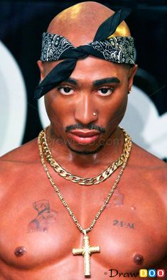 a shirtless man with a cross on his chest wearing a bandana and gold chains