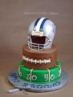 a three tiered cake with a football helmet on top