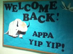 a welcome back sign hanging on the wall