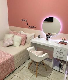 a room with a bed, desk and mirror on the wall next to a white chair