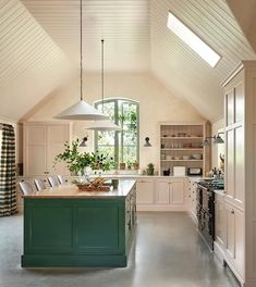 a large kitchen with an island in the middle and lots of counter space on one side