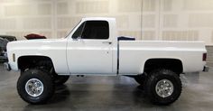 a white pickup truck parked in a garage