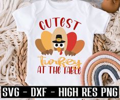 a turkey wearing a pilgrim hat with the words cutest turkey at the table on it