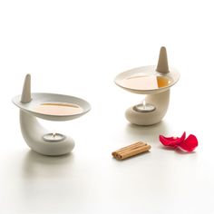 three bowls with different types of food in them on a white surface next to cinnamon sticks and an orange slice