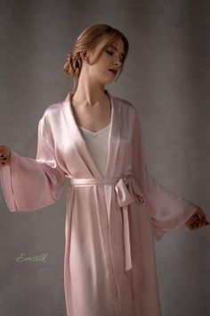 This robe is perfect as wedding robe/sleepwear.100 % designed and handmade by Emsilk. I am pleased to offer your garments made to measure at no extra cost. * Detail: - Pale pink 100% pure silk robe (many other colors are available)- Matching belt is included- Shawl collar style- Midi length/ other length as requested- Best quality silk, 100 % pure mulberry silk and hugs your body so smoothly that you will not want to take it off. I can give small swatch for testing.- The model is 5'8 tall and we Elegant Robe For Wedding Night In Spring, Elegant Spring Wedding Night Robe, Silk Long Sleeve Sleepwear For Wedding Night, Elegant Satin Sleepwear For Spring, Elegant Long Sleeve Sleepwear For Wedding Night, Elegant Long Sleeve Bridesmaid Sleepwear, Elegant Spring Wedding Robe, Feminine Satin Robe For Loungewear, Elegant Satin Robe For Spring