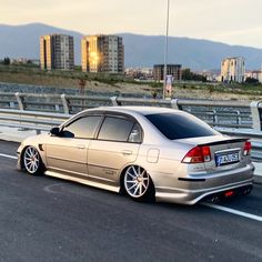 a silver car parked on the side of a highway