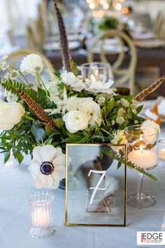 a table with flowers and candles on it