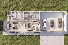 an aerial view of a house with two cars parked in the driveway