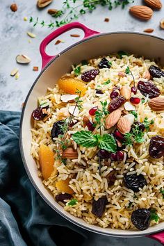 a pot filled with rice, nuts and dried cherries