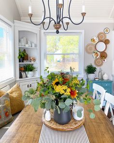 a wooden table topped with a vase filled with flowers