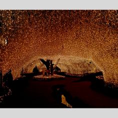 the inside of a tunnel covered in lights