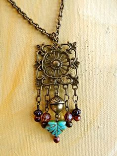 All the hues of Autumn bring a special warmth and sparkle to the lovely necklace. OX brass charms, various glass and ceramic beads were hung from brass chain, attached to a vintage style filigree pendant. This can be worn with many styles and colors so it's a perfect choice for your jewelry collection. A one of a kind artisan piece. Vintaj Jewelry, Vintage Jewelry Crafts, Filigree Jewelry, Assemblage Jewelry, Boho Style Jewelry, Filigree Pendant, Necklace Turquoise, Homemade Jewelry, Brass Charms